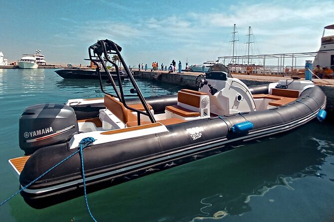 Private Speedboat swimming and Dolphin Watching in Hurghada - Snacks, fruit, and a simple boat lunch setup